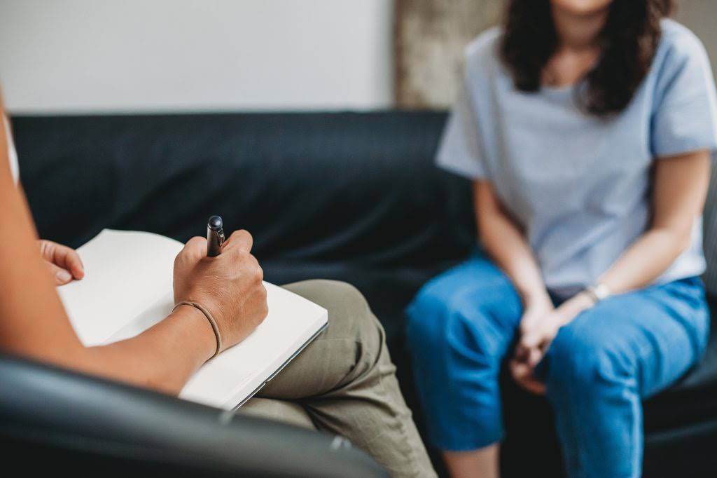 Psychotherapy session, woman talking to his psychologist in the