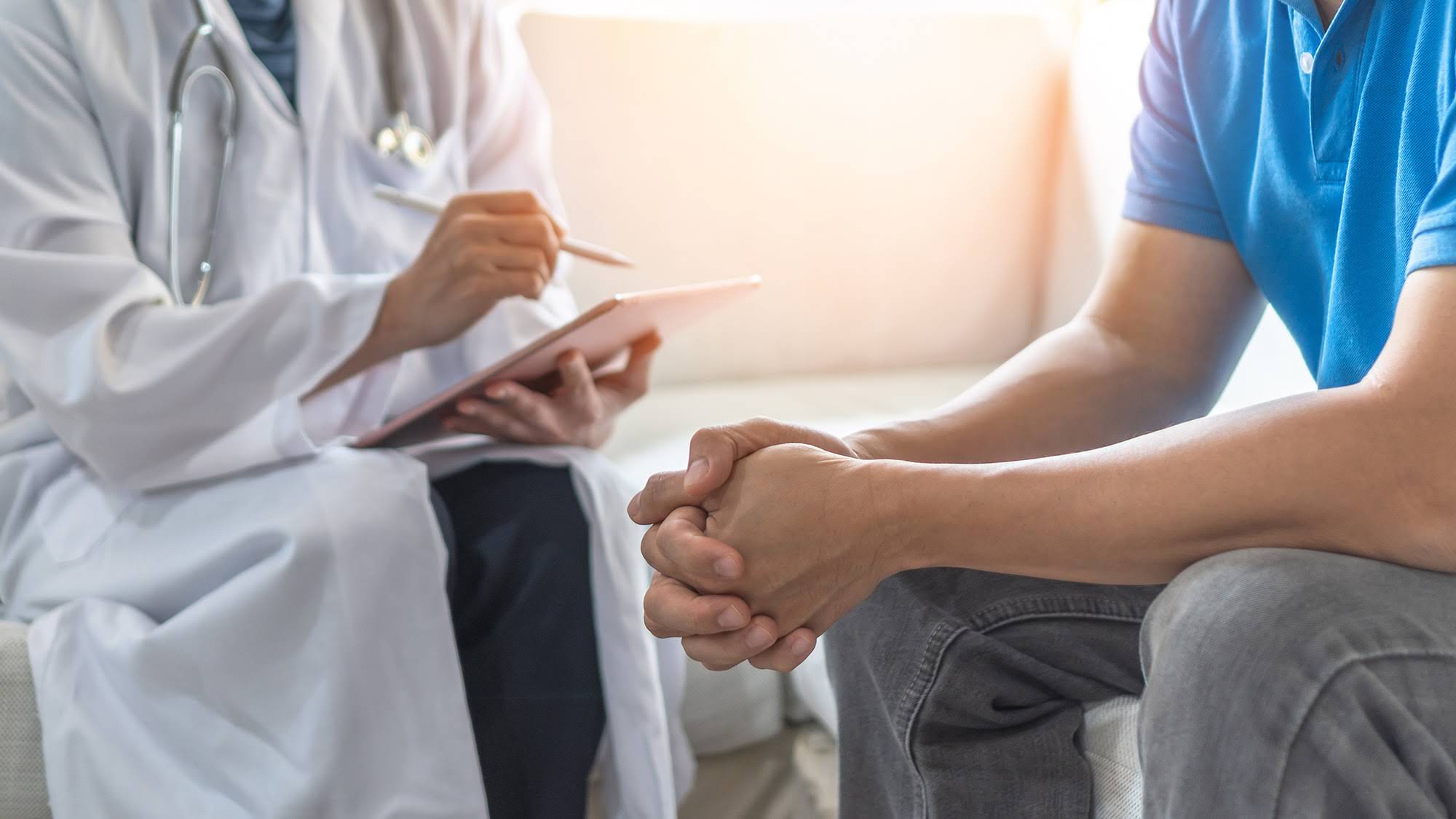 Men's health exam with doctor or psychiatrist working with patie