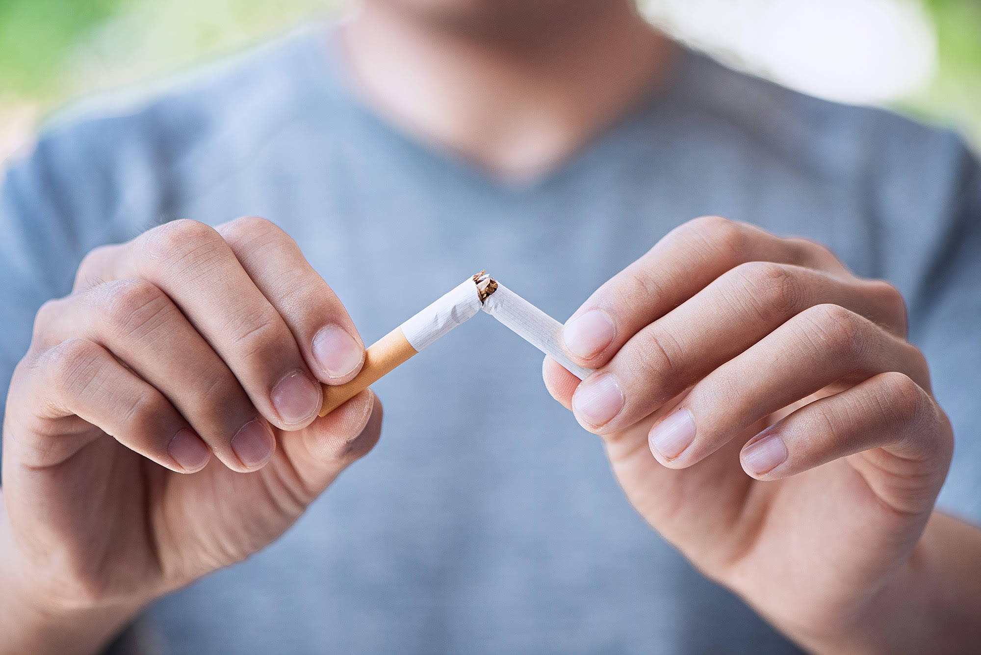 Stop cigarette, man hands breaking the cigarette for good health